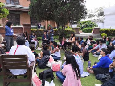 Participants sit outside at the conference