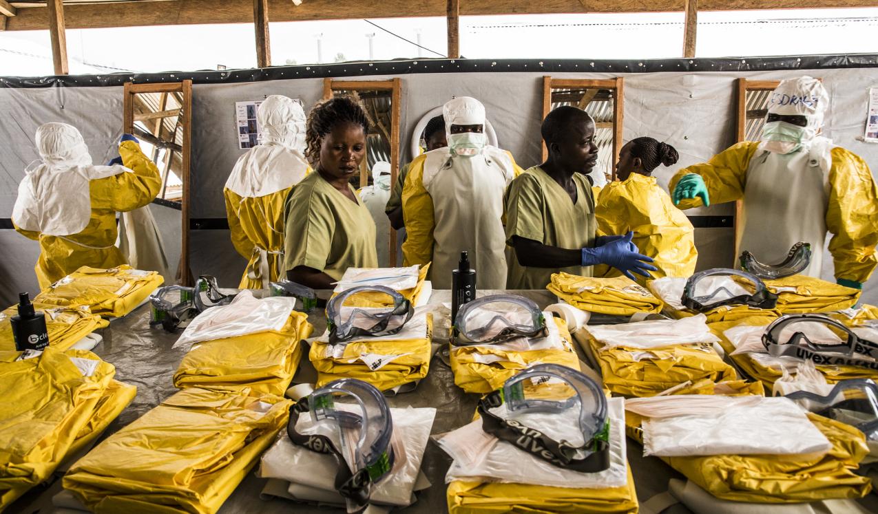 Health workers put on their personal protective equipment before treating people suspected of having Ebola at the Ebola Transition Center in the Democratic Republic of Congo. © World Bank/Vincent Tremeau