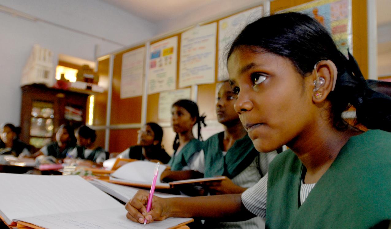 A girl with a hearing aid amongst peers at a school in Chennai, India. © Pippa Ranger/Department for International Development