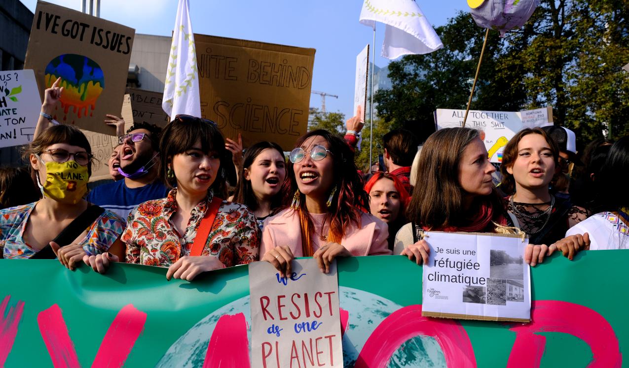 Demonstrators raise placards at one of the protests outside COP26 in Glasgow, November 2021 ©Alexandros Michailidis/Shutterstock/2055371690