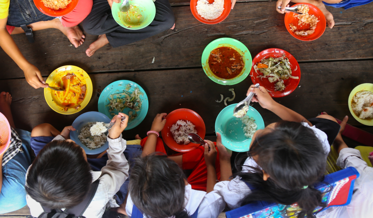 Children having lunch in asian school sitting on the floor ©Anna Issakova/shutterstock