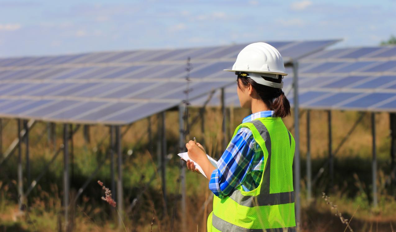 A young woman engineer checking solar panel at solar power plant © Monthira | Shutterstock ID: 786784237