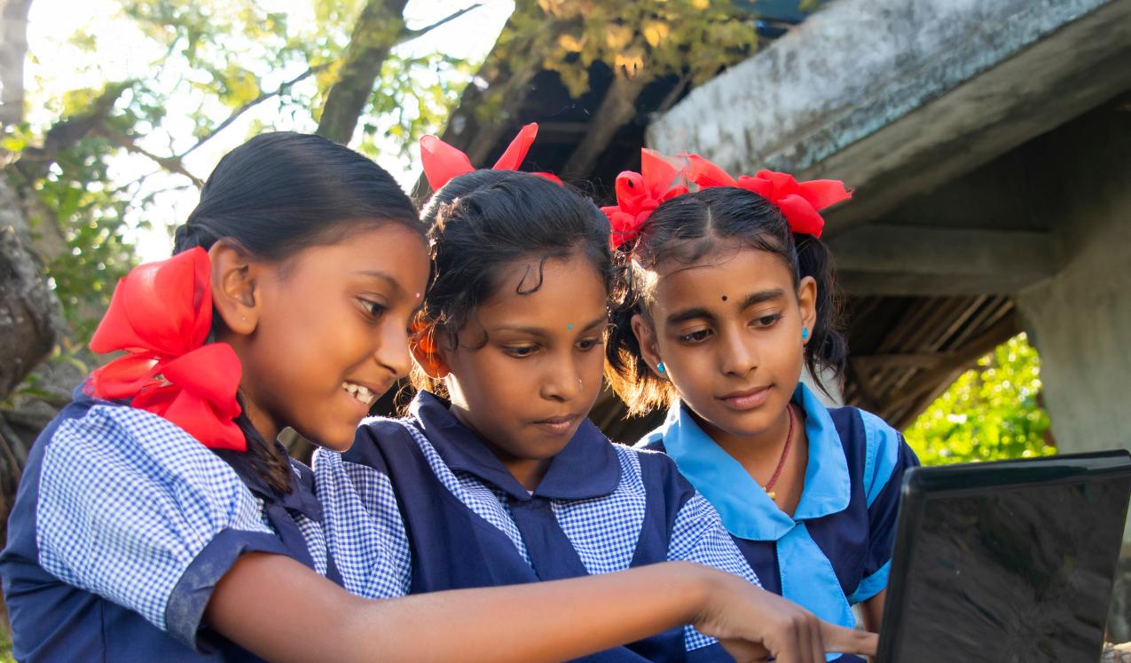 School girls at a school in a rural Indian village using a laptop. © poltu Shyamal | Shutterstock ID: 1994400374