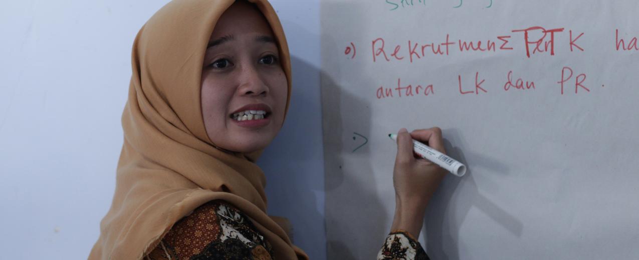 A woman taking notes at the convening