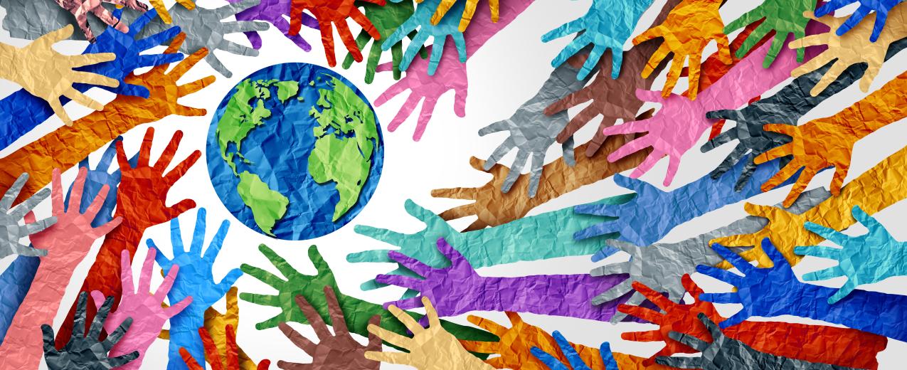 A collage of brightly coloured paper hands reaching towards a paper earth. © Lightspring | Shutterstock ID: 1814911268