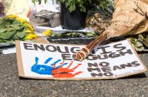 Sign and flowers at a shrine for a woman who was raped and murdered in Cape Town, South Africa. © Roxane 134 | Shutterstock ID: 2208321545