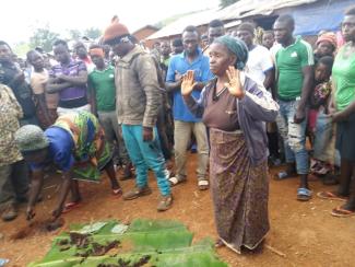 Saint Albert's Charity working with communities to reduce stigma associated with women digging graves. A grandmother digging a grave. © Saint Albert's Charity