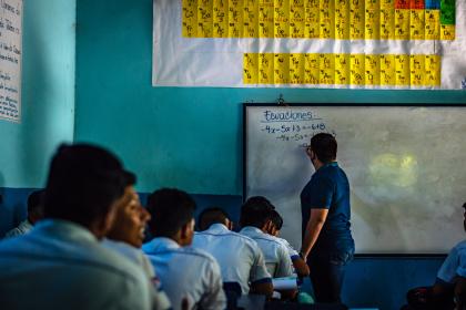 A teacher guiding students in a classroom at a Guatemalan college in Guazacapan. © ShutterPrice | Shutterstock ID: 1223048206