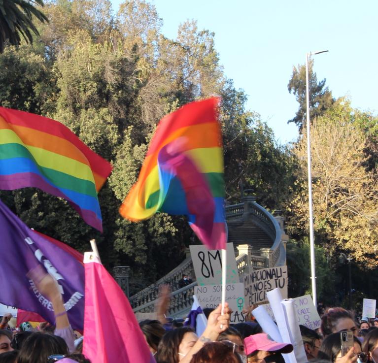 LGBTQ flags fly at a 8M march in Santiago, Chile